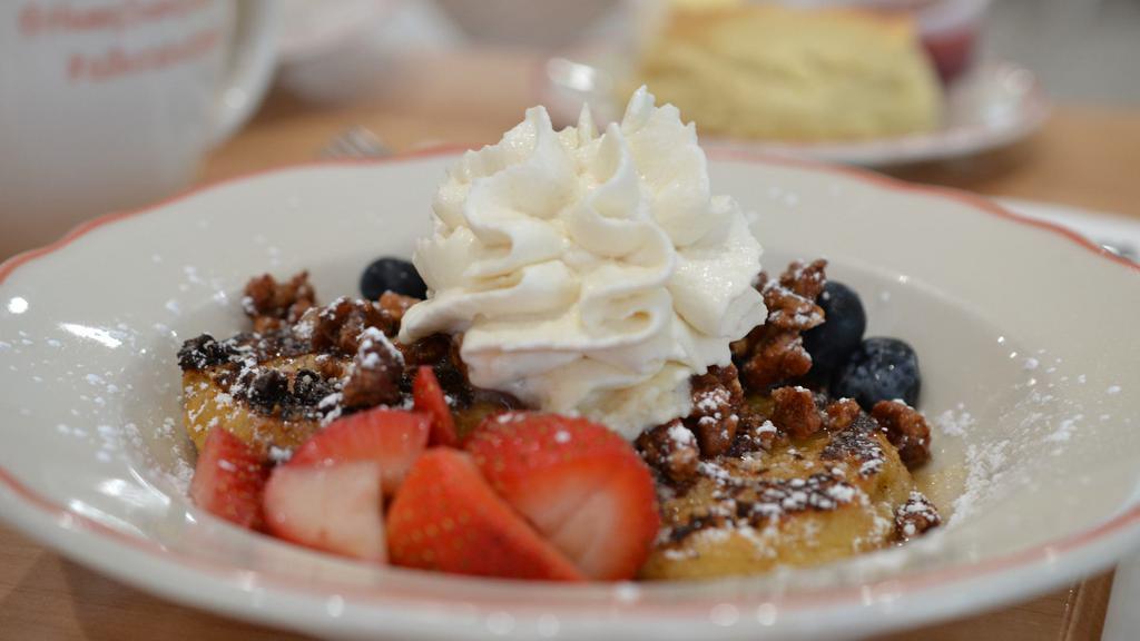 Biscuit French Toast · Maple syrup, whipped cream, candied pecans, fresh berries, powdered sugar.