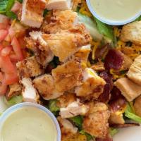Crispy Chicken Salad · Fried chicken, bacon, romaine, spinach, cheddar cheese, avocado, tomato, biscuit croutons, c...