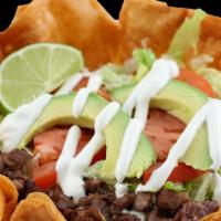 Taco Salad · Served with meat of choice, beans, rice, sour cream, avocado, lettuce, tomato and cheese.