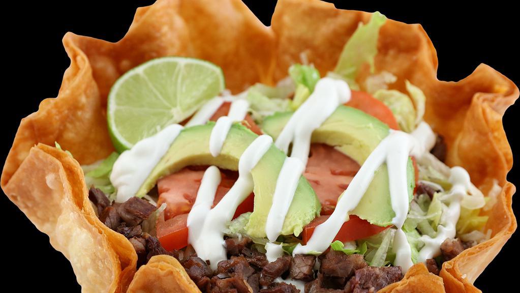 Taco Salad · Served with meat of choice, beans, rice, sour cream, avocado, lettuce, tomato and cheese.
