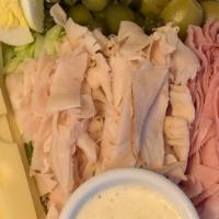 Hudsons Maurice Salad · Ham, Turkey, Swiss Cheese, Hard Boiled Egg, Sweet Gherkins on a bed of Iceberg Lettuce, w/Le...
