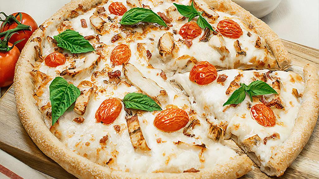 Alfredo Pomodoro · Sarpino's traditional pan pizza baked to perfection and topped with creamy Alfredo sauce, tender grilled chicken strips, crispy bacon, roasted garlic, ripe tomatoes, our signature gourmet cheese blend, fresh basil and sprinkled with Parmesan.