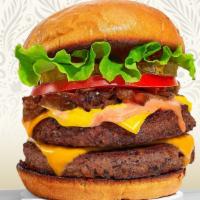 Double Trouble Burger · Two plant-based impossible meat patties topped with cheddar vegan cheese, grilled onions, mu...