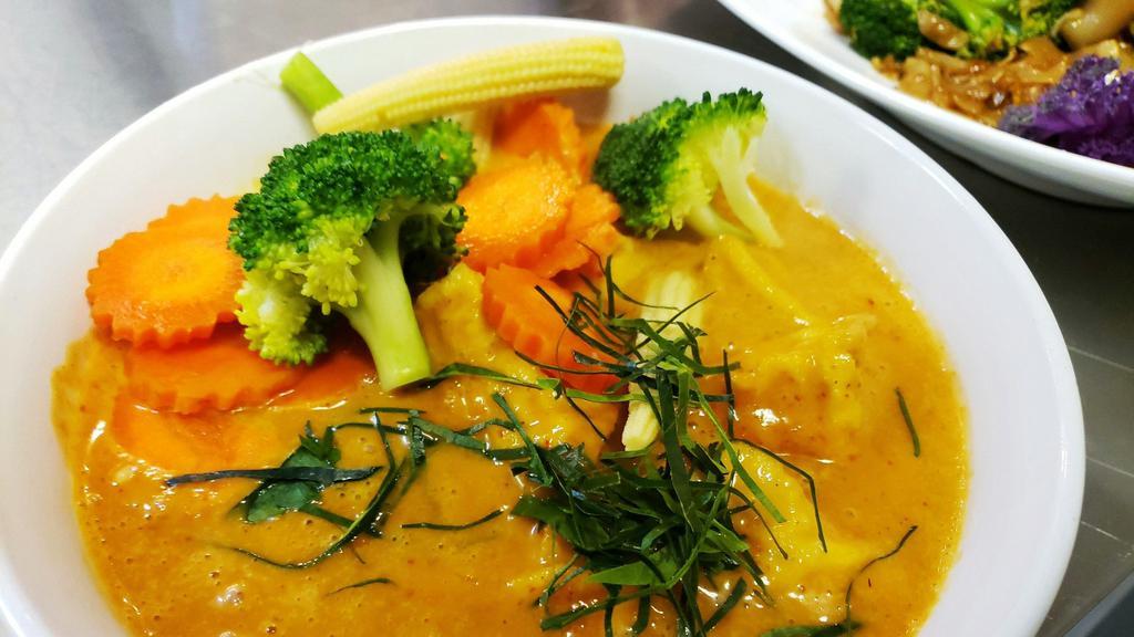 Panang Curry · Vegetarian available. Spicy. Your choice of meat or tofu cooked in coconut milk, panang curry, kaffir lime leaves, broccoli, baby corn, carrot. Served with steamed rice.