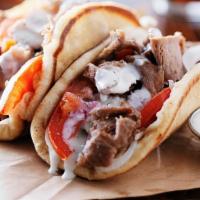 Gyros Sandwich · Best gyros slowly cooked on a spit and wrapped in a pita with tzatziki, onion and tomatoes.