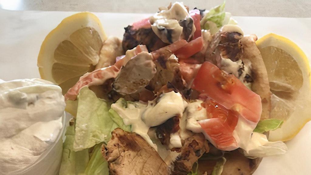 Grill Chicken On Pita · Char-broiled marinated chicken breast tzatziki sauce, lettuce and tomatoes.
