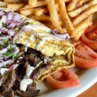 Shawarma Omelette · 2 organic eggs rolled over tomatoes, your choice of beef and lamb or chicken shawarma, serve...