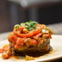 Imam Bayildi · Sliced eggplant topped with organic chickpeas, cooked with fresh tomatoes, onions, garlic, s...