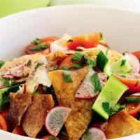 Fattoush Salad · Pita crackers, chopped tomatoes, cucumbers, radish, mint, parsley, onion, lettuce, and sumac...