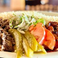 Shawarma Combo Plate · Beef, lamb and chicken shawarma served on a bed of basmati rice with lettuce, sumac onions, ...