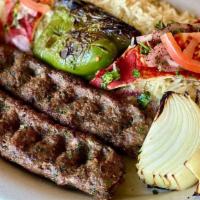 Kafta Kabob Plate · Ground beef and lamb, mixed with herbs, spices, onions, and parsley, grilled, topped with be...