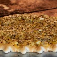 Armenian Cheese Mana'Eesh · Vegan. 
A blend of white cheese, onions, sumac, spices and dried mint. Vegetarian.