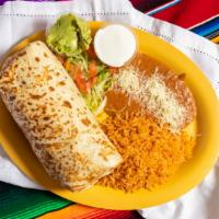 Burrito Dinner · Burrito served with guacamole, sour cream, rice, and beans. Choice of ground beef, Chicken o...