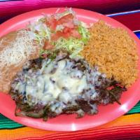 Bistec Con Rajas Y Queso · Chopped ribeye steak cooked with slices of poblano pepper, tomato, onions and topped with me...