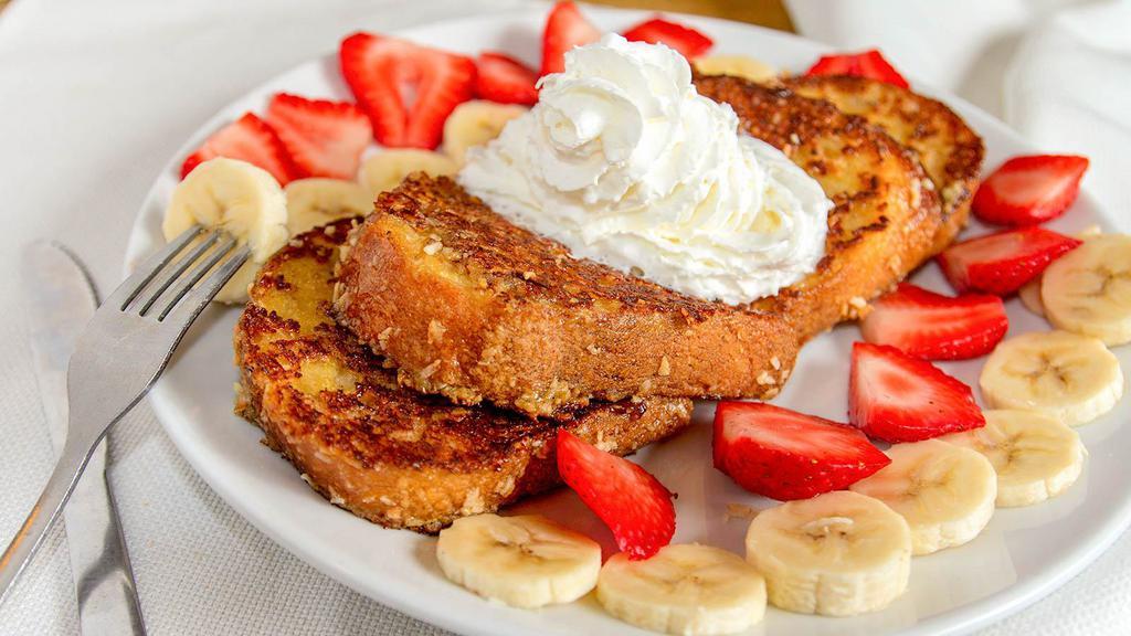 French Toast Crunch · French toast coated with a sweet granola-crunch, strawberries, bananas, and whipped cream.