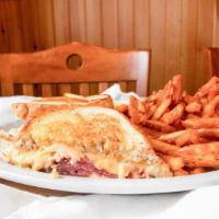 Signature Reuben · Thinly sliced corned beef stacked high, sauerkraut, Swiss cheese and thousand island on thic...
