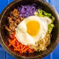 Bebimbop · Rice bowl with beef, bean sprouts, carrots, zucchini, red cabbage topped with an over-easy e...