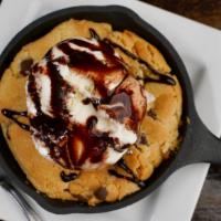 Skillet Cookie · Your choice of cookie topped with 2 scoops of ice cream and a chocolate drizzle.