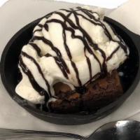Brownie Sundae · A brownie topped with 2 scoops of ice cream and a chocolate drizzle.