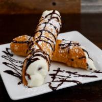 Cannoli · 2 Italian pastry filled with sweet creamy filling and chocolate chips then topped with powde...
