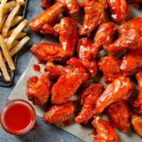 Bone-In Wings · Bone-In Wings tossed in your choice of sauces and served with Ranch or Blue Cheese.