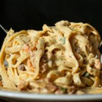 Crawfish ＆ Andouille Fettuccine · Crawfish tail meat sautéed with spicy andouille sausage tossed with a Parmesan cream sauce.