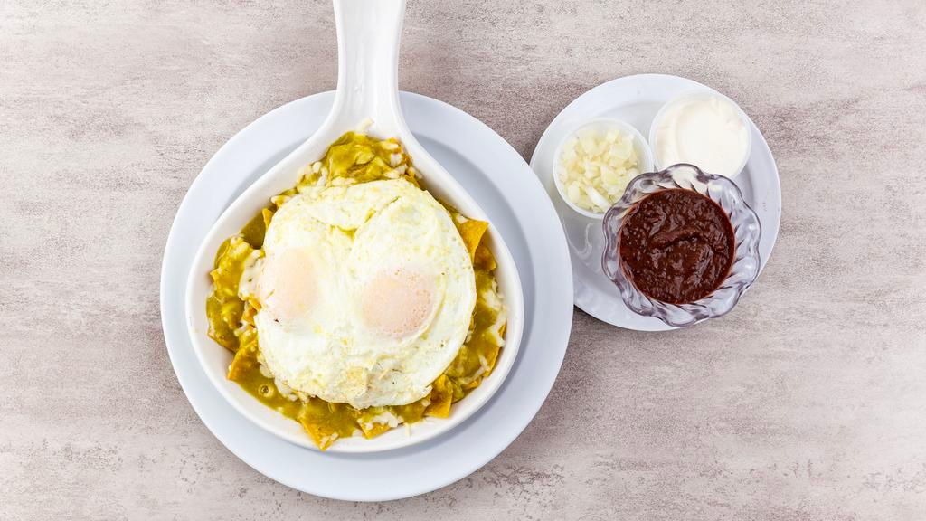 Chilaquiles · Now serving homemade tortilla chips covered in a delicious green or red salsa topped with mozzarella cheese and two eggs any style on top. Side black beans, sour cream and onion.