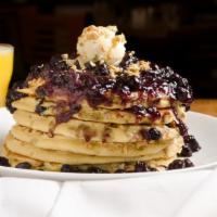 Monday Blues · Full stack filled with plump blueberries, crunchy granola and topped with butter and blueber...