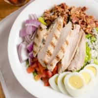 Cobb Salad · Gluten-free. Greens, grilled chicken, tomatoes, red onion, Gorgonzola, crisp bacon, and hard...