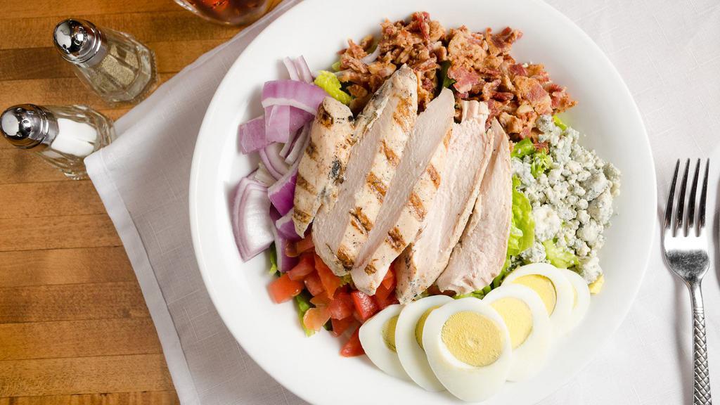 Cobb Salad · Gluten-free. Greens, grilled chicken, tomatoes, red onion, Gorgonzola, crisp bacon, and hardboiled egg served with our housemade balsamic vinaigrette. 1047 cal.