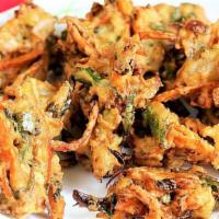 Mixed Vegetable Pakora (6 Pieces) · Mixed vegetable fritters battered with chickpea flour.