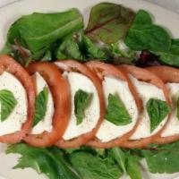Caprese Salad · Sliced tomatoes layered with fresh mozzarella cheese, and fresh basil, served with extra vir...