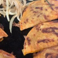 Birria Tacos · Three pieces birria tacos with cilantro, onion and a cup of consommé.