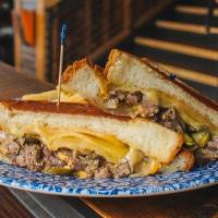 Grilled Cheese Beef Tosti · Shredded slow-cooked beef, smoked gouda, honey glazed onions, sliced jalapeno, on fluffy cha...