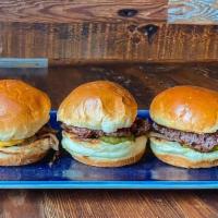 Bier Cheese Sliders · Three mini smash-burgers topped with honey glazed onions, pickles, and bier cheese aioli