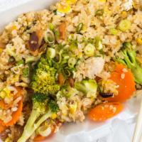 Garlic Fried Rice · Wok-fried rice with egg, fried sliced garlic, broccoli, carrots, scallions.