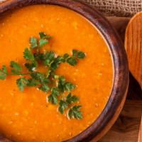 Lentil Soup · Made with red lentils, onions and spices, garnished with lemon, cumin and parsley.