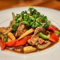 Pepper Steak · A hearty dish made with flank steak sauteed with bell peppers, baby corn and onions in a ric...