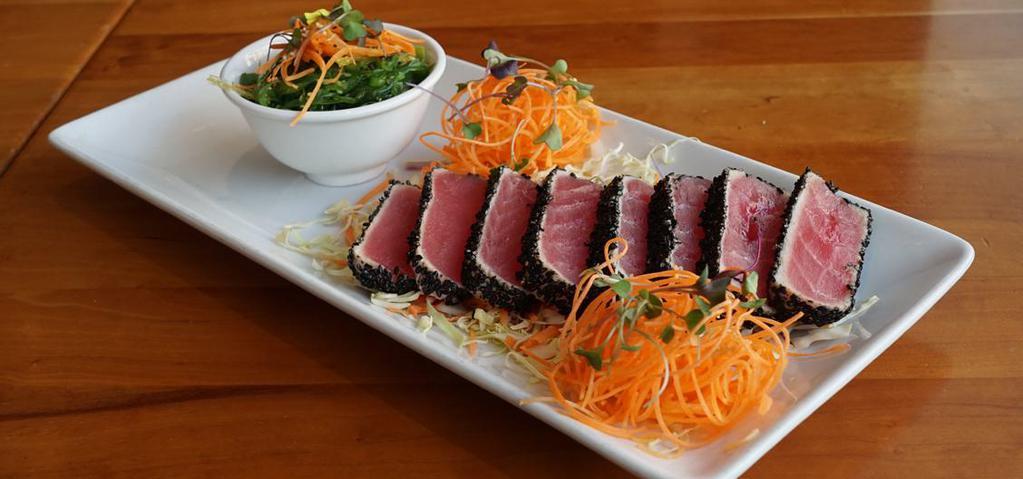Tuna Tataki · Lightly seared tuna coated with roasted black sesame & pepper. Served w. seaweed salad and a spicy sesame Ponzu sauce.