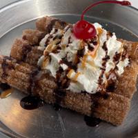 Charro Churro  · Sweet Fried dough sticks rolled in cinnamon and sugar. Topped with whipped cream, cajeta (so...