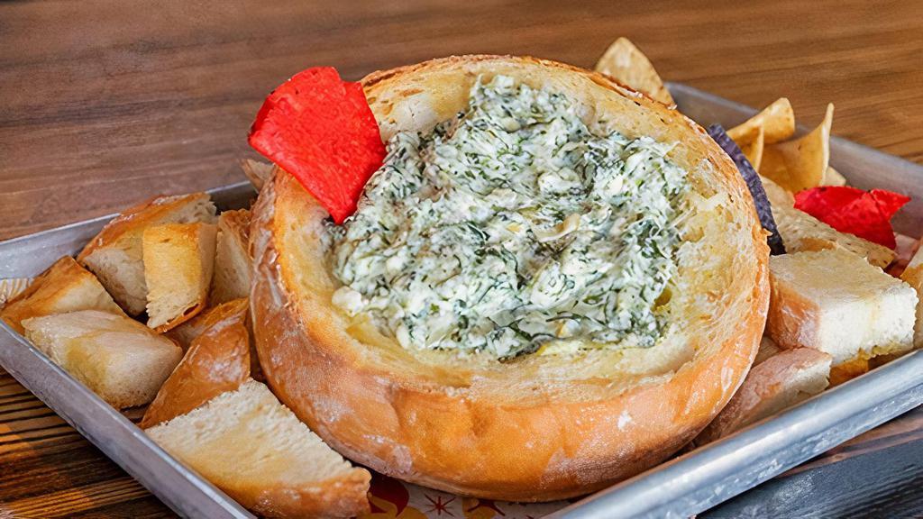 Spinach Artichoke Dip · Our homemade artichoke dip served in a bread bowl