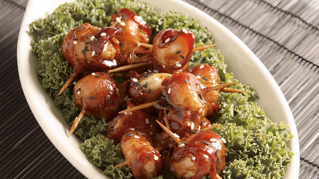 Bacon Wrapped Water Chestnuts · Crunchy water chestnuts wrapped in bacon tossed in a light oriental glaze and topped with sesame seeds.