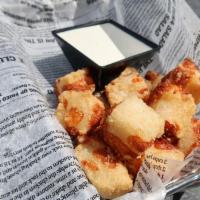 Cheese Bites · A combination of beer battered dough and white cheddar cheese, fried until golden brown, ser...