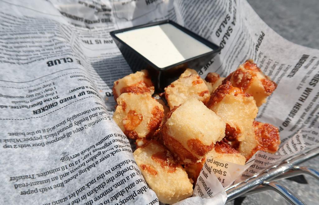 Cheese Bites · A combination of beer battered dough and white cheddar cheese, fried until golden brown, served with our homemade ranch dressing!