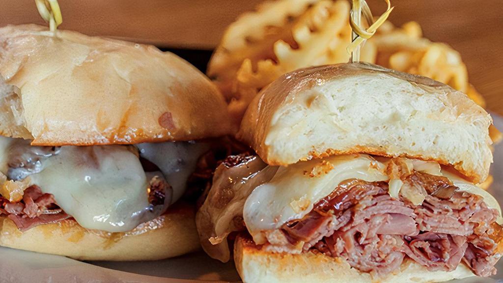 Smothered French Dip · Shaved roast beef smothered with sautéed onions, mushrooms and Monterey Jack cheese on a fresh sub roll. Served with au jus for dipping.