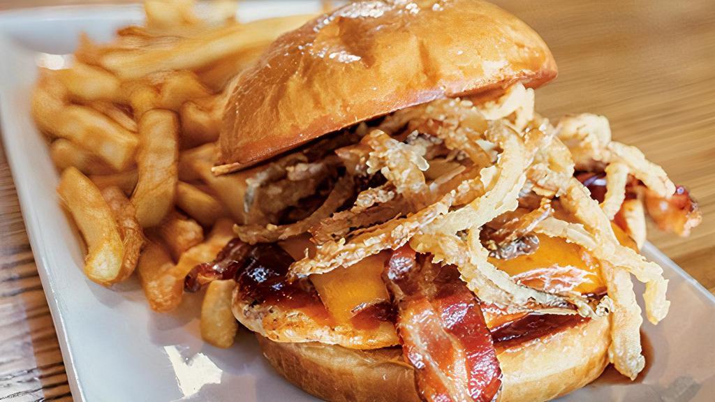 The Cowboy Chicken Sandwich · Your choice of chicken topped with bacon, BBQ sauce, cheddar cheese and onion strings.
