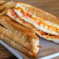 Ultimate Grilled Cheese · A doubled stacked grilled cheese loaded with Cheddar, Monterey Jack and Swiss cheese, crispy...