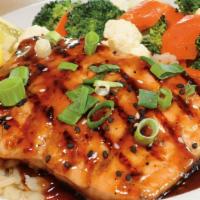 Grilled Oriental Salmon · Light and flaky, wood grilled Atlantic salmon topped with teriyaki oriental sesame sauce, ch...