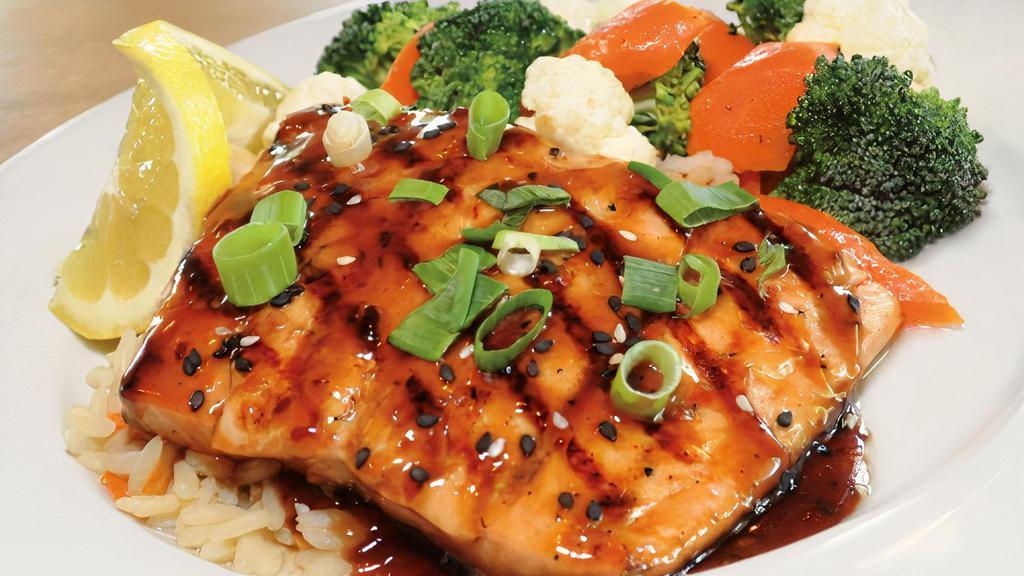 Grilled Oriental Salmon · Light and flaky, wood grilled Atlantic salmon topped with teriyaki oriental sesame sauce, chopped scallions and sesame seeds.