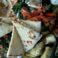 Mediterranean Vegetable Plate · Tabouli, hummus with pita, artichoke hearts,
fattoush salad, grape leaf, black olives &
a bl...